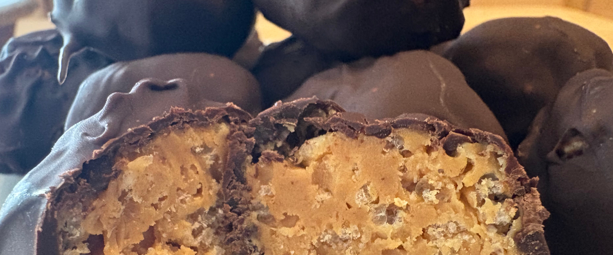 dark chocolate peanut butter crispy balls stacked with one cut open