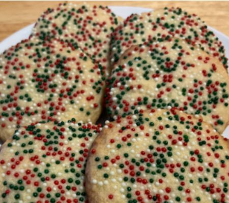 close up of a plate of sprinkle butter cookies